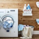 Interior of a real laundry room with a clothes dryer at the window at home